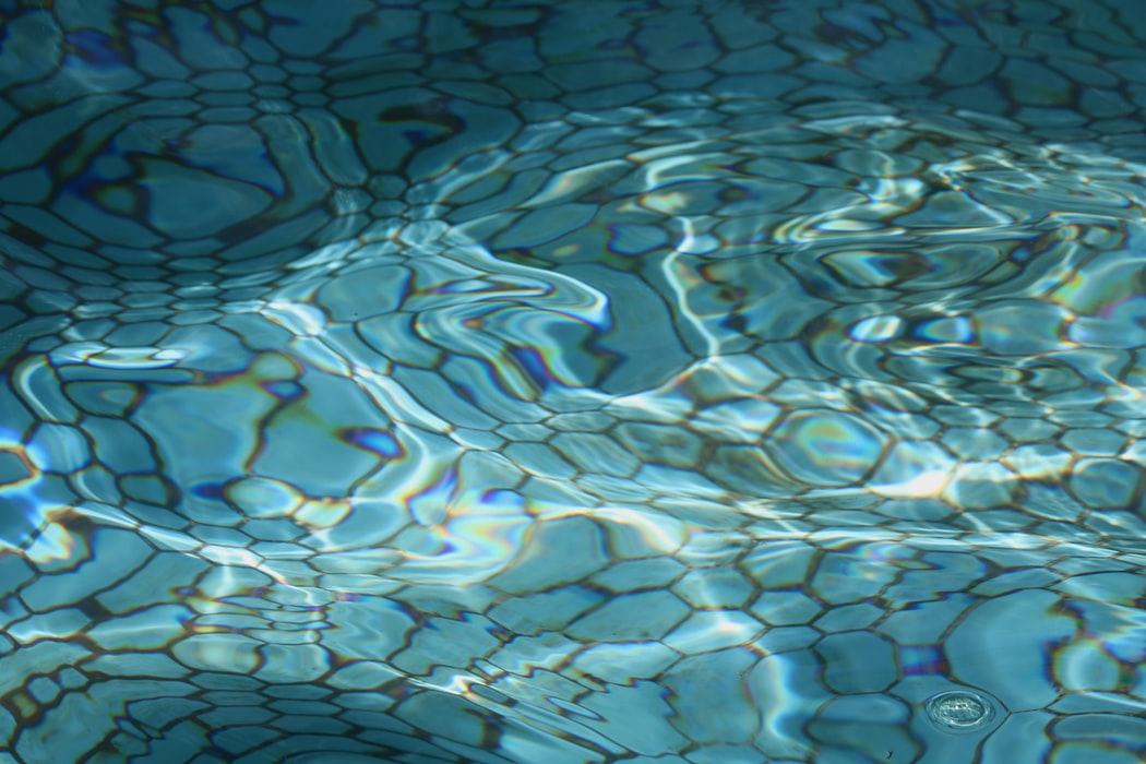 A clean swimming pool floor with rippling water effect