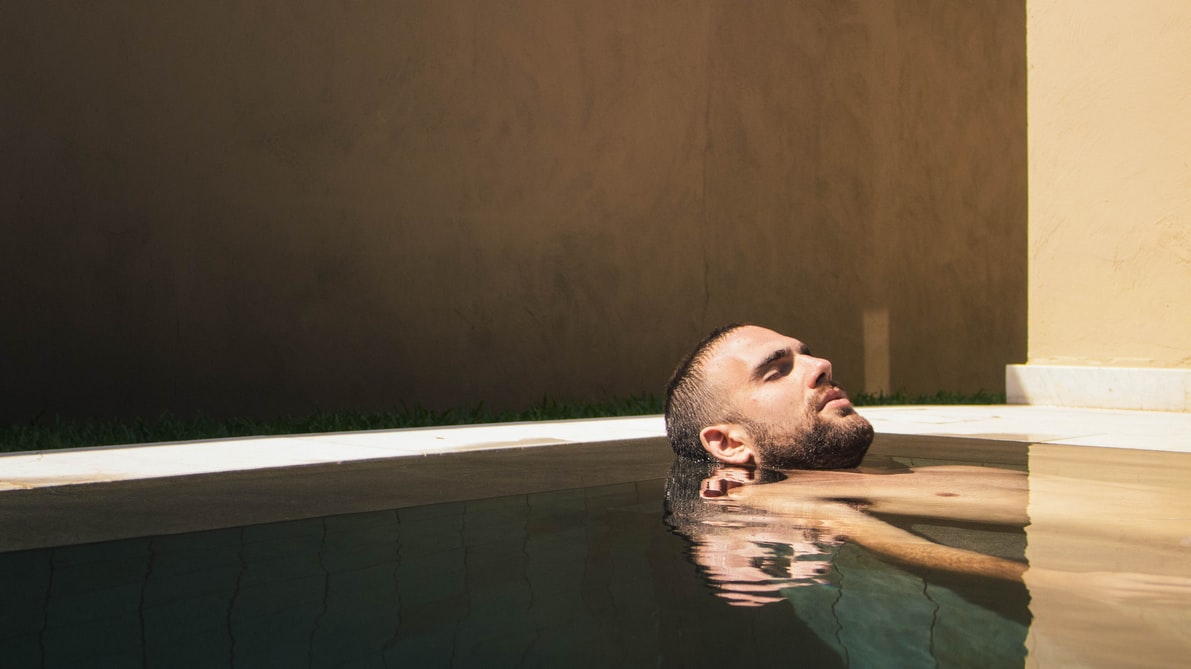 A man relaxing in a still hot tub